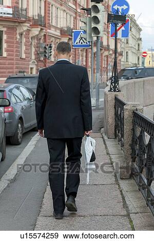 Rear view of a businessman on a sidewalk, St. Petersburg, Russia View Large Photo Image Stock Photo - Rear view of a businessman on a sidewalk, St. Petersburg, Russia. Fotosearch
