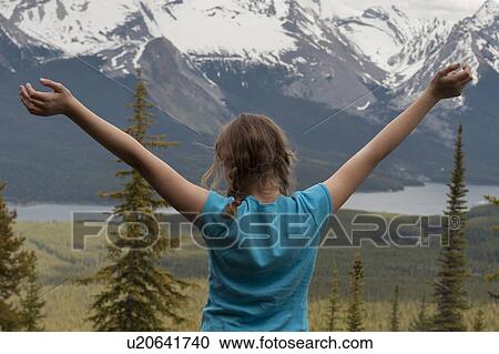 Rear view of a girl standing with arms outstretched, Bald Hills Trail, Jasper National Park, Alberta, Canada View Large Photo Image Stock Image - Rear view of a girl standing with arms outstretched, Bald Hills Trail, Jasper National Park, Alberta, Canada. Fotosearch