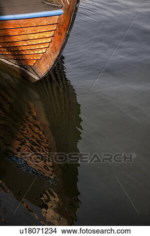 Picture - Reflection of a boat on water, Skeppsholmen, Stockholm, Sweden. Fotosearch