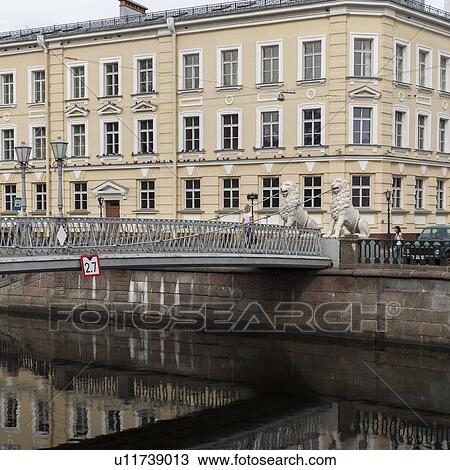 Stock Image - Reflection of a bridge on water, Lions Bridge, Griboyedov Canal, St. Petersburg, Russia. Fotosearch