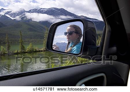 Reflection of girl on the side view mirror of a car, Jasper National Park, Alberta, Canada View Large Photo Image Stock Image - Reflection of girl on the side view mirror of a car, Jasper National Park, Alberta, Canada. Fotosearch