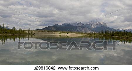 Reflection of mountains in Jasper Lake, Jasper National Park, Alberta, Canada View Large Photo Image Stock Image - Reflection of mountains in Jasper Lake, Jasper National Park, Alberta, Canada. Fotosearch