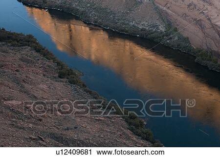 Stock Image - Reflection of rocks in water, Colorado River, Arizona-Utah, USA. Fotosearch