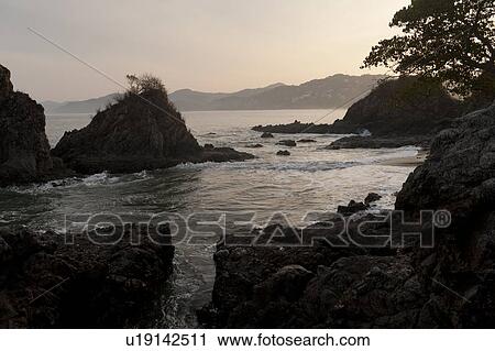 Stock Image - Rock formations at the coast, Sayulita, Nayarit, Mexico. Fotosearch
