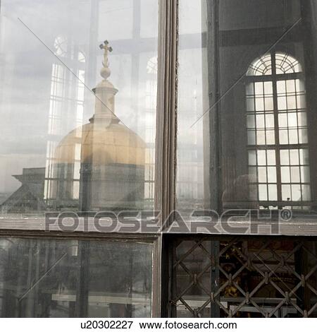 Stock Photo - Saint Isaac's Cathedral viewed through a window of a building, St. Petersburg, Russia. Fotosearch