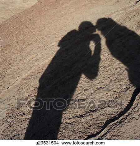 Picture - Shadow of a couple on a rock, Horseshoe Bend, Glen Canyon National Recreation Area, Arizona-Utah, USA. Fotosearch