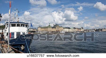 Stock Photo - Ship at a dock with buildings in the background, Stockholm, Sweden. Fotosearch
