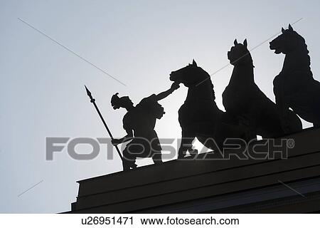 Stock Image - Silhouette of sculptures on a triumphal arch, General Staff Building, Palace Square, St. Petersburg, Russia. Fotosearch