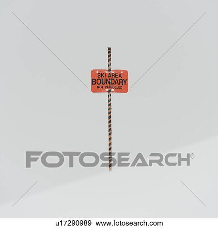 Stock Photo - Ski area boundary sign in snow, Whistler, British Columbia, Canada. Fotosearch