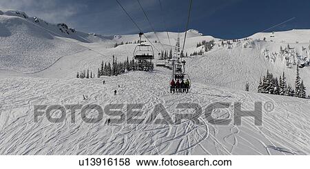 Stock Photo - Ski lifts at snowy valley in winter, Symphony Amphitheatre, Whistler, British Columbia, Canada. Fotosearch