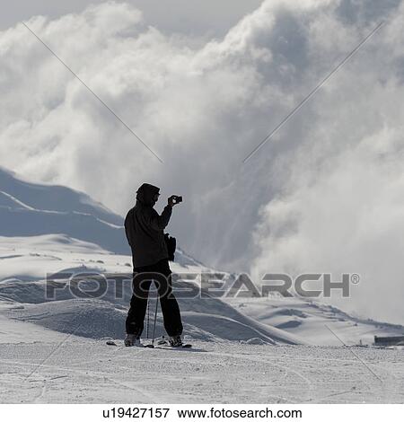 Skier taking pictures of clouds, Whistler, British Columbia, Canada View Large Photo Image Stock Photo - Skier taking pictures of clouds, Whistler, British Columbia, Canada. Fotosearch