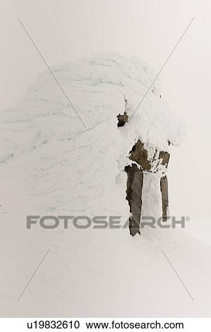 Stock Image - Snow covered Inuksuk, Whistler Mountain, Whistler, British Columbia, Canada. Fotosearch