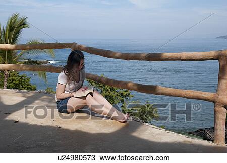 Teenage girl reading a book at the seaside, Sayulita, Nayarit, Mexico View Large Photo Image Stock Image - Teenage girl reading a book at the seaside, Sayulita, Nayarit, Mexico. Fotosearch