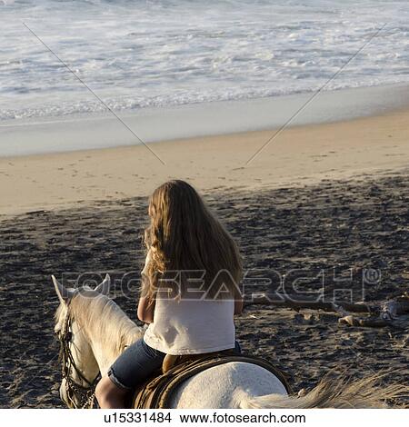 Picture - Teenage girl riding a horse on the beach, Sayulita, Nayarit, Mexico. Fotosearch