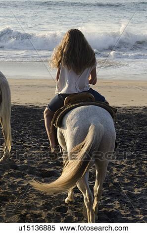 Stock Photography - Teenage girl riding a horse on the beach, Sayulita, Nayarit, Mexico. Fotosearch