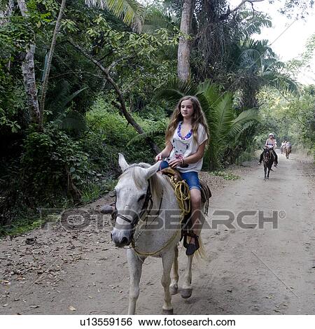 Stock Photograph - Teenage girl riding a horse, Sayulita, Nayarit, Mexico. Fotosearch
