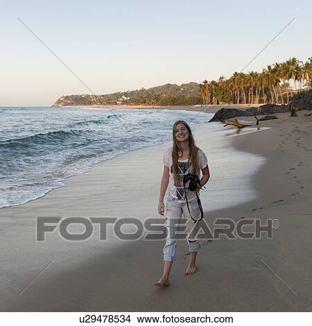 Teenage girl walking on the beach, Sayulita, Nayarit, Mexico View Large Photo Image Picture - Teenage girl walking on the beach, Sayulita, Nayarit, Mexico. Fotosearch
