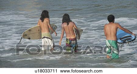 Three men carrying surfboards in the sea, Sayulita, Nayarit, Mexico View Large Photo Image Stock Image - Three men carrying surfboards in the sea, Sayulita, Nayarit, Mexico. Fotosearch