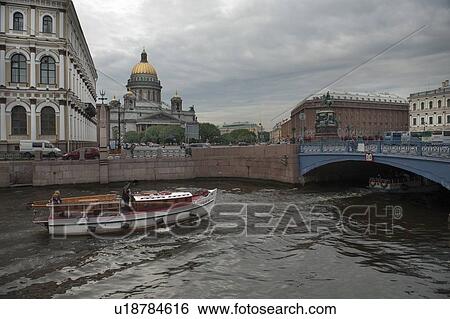Stock Photograph - Tourboat in the Moyka River with Saint Isaac's Cathedral in the background, St. Petersburg, Russia. Fotosearch