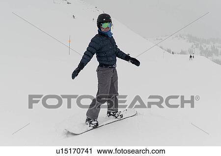Stock Image - Tourist snowboarding, Whistler, British Columbia, Canada. Fotosearch