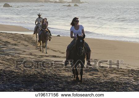Tourists enjoying horseback riding on the beach, Sayulita, Nayarit, Mexico View Large Photo Image Stock Photograph - Tourists enjoying horseback riding on the beach, Sayulita, Nayarit, Mexico. Fotosearch