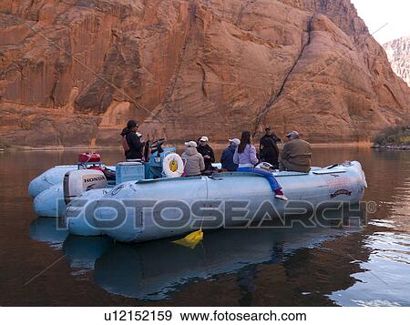 Stock Photo - Tourists on a rafter in a river, Colorado River, Glen Canyon National Recreation Area, Arizona-Utah, USA. Fotosearch
