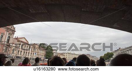Stock Image - Tourists on a tourboat, Fontanka River, St. Petersburg, Russia. Fotosearch