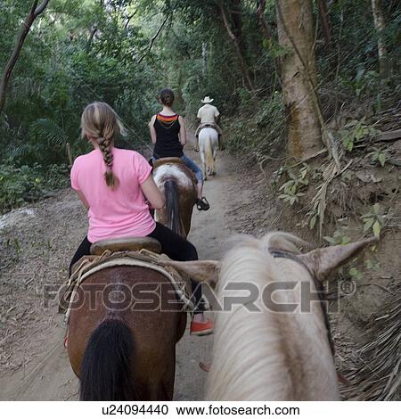 Stock Image - Tourists riding horses on a trail, Sayulita, Nayarit, Mexico. Fotosearch