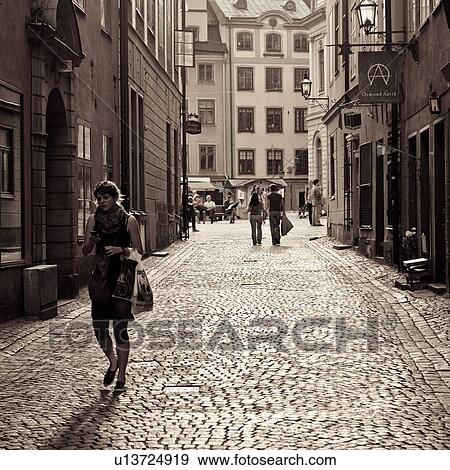 Stock Photo - Tourists shopping on a street, Gamla Stan, Stockholm, Sweden. Fotosearch