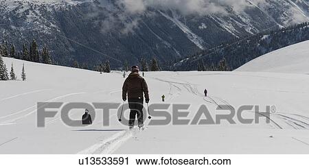Stock Image - Tourists skiing, Sun Bowl, Whistler, British Columbia, Canada. Fotosearch