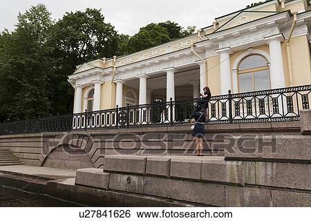 Stock Photograph - Tourists standing at a riverside, Fontanka River, St. Petersburg, Russia. Fotosearch