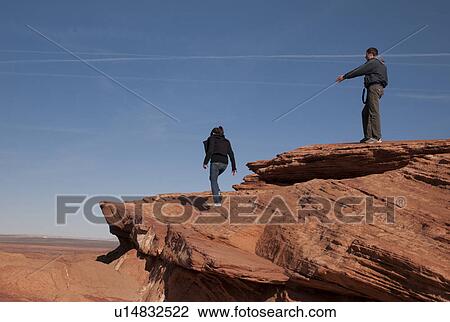 Tourists standing on a rock, Horseshoe Bend, Glen Canyon National Recreation Area, Arizona-Utah, USA View Large Photo Image Stock Image - Tourists standing on a rock, Horseshoe Bend, Glen Canyon National Recreation Area, Arizona-Utah, USA. Fotosearch