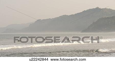 Picture - Tourists surfing in the sea, Sayulita, Nayarit, Mexico. Fotosearch