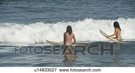 Stock Photo - Tourists surfing in the sea, Sayulita, Nayarit, Mexico. Fotosearch