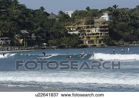 Stock Photo - Tourists surfing in the sea, Sayulita, Nayarit, Mexico. Fotosearch
