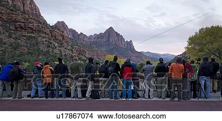Picture - Tourists taking picture of cliffs from an observation point, Utah, USA. Fotosearch