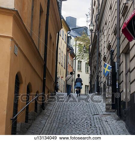 Stock Photo - Tourists walking in a street, Gamla Stan, Stockholm, Sweden. Fotosearch