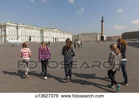 Stock Photo - Tourists walking towards the Alexander Column, Winter Palace, State Hermitage Museum, Palace Square, St. Petersburg, Russia. Fotosearch