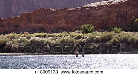 Two people standing in a river, Colorado River, Glen Canyon National Recreation Area, Arizona-Utah, Utah, USA View Large Photo Image Stock Image - Two people standing in a river, Colorado River, Glen Canyon National Recreation Area, Arizona-Utah, Utah, USA. Fotosearch