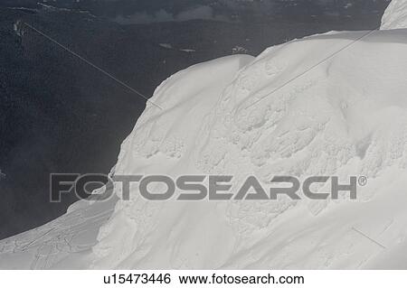 Stock Photograph - View of a valley from a snow covered mountain, Whistler, British Columbia, Canada. Fotosearch