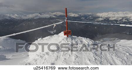 Stock Photo - Warning sign with boundary line on snowcapped mountain, Whistler, British Columbia, Canada. Fotosearch