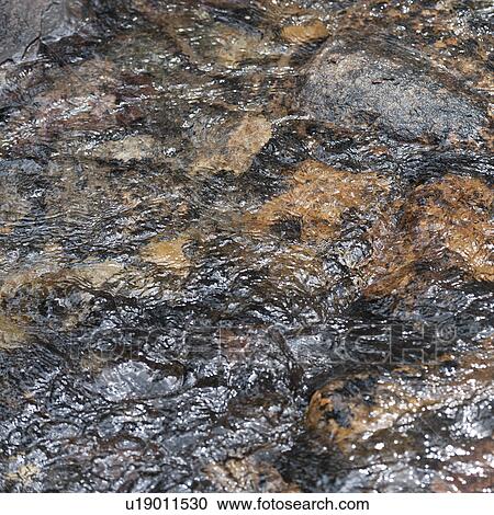 Stock Image - Water flowing over rocks, Jasper National Park, Alberta, Canada. Fotosearch