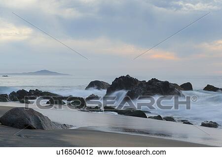 Stock Image - Waves breaking on rocks, Sayulita, Nayarit, Mexico. Fotosearch