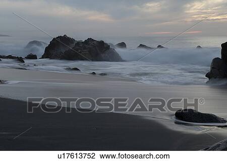 Stock Image - Waves breaking on rocks, Sayulita, Nayarit, Mexico. Fotosearch