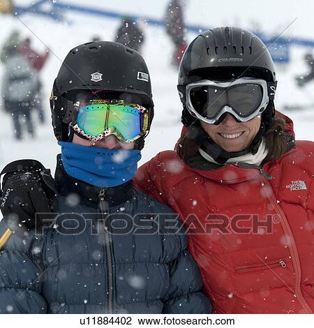 Woman in ski gear smiling with her friend during snowing, Whistler, British Columbia, Canada View Large Photo Image Stock Image - Woman in ski gear smiling with her friend during snowing, Whistler, British Columbia, Canada. Fotosearch