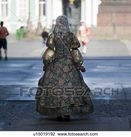 Stock Image - Woman in traditional costume at Winter Palace, State Hermitage Museum, Palace Square, St. Petersburg, Russia. Fotosearch