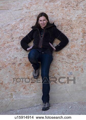 Woman leaning against a rock, Utah, USA View Large Photo Image Picture - Woman leaning against a rock, Utah, USA. Fotosearch