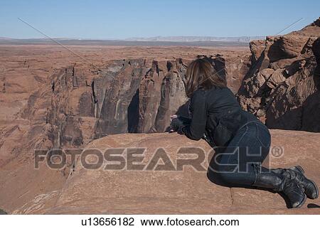 Woman leaning on a rock looking at a view, Horseshoe Bend, Glen Canyon National Recreation Area, Arizona-Utah, USA View Large Photo Image Stock Image - Woman leaning on a rock looking at a view, Horseshoe Bend, Glen Canyon National Recreation Area, Arizona-Utah, USA. Fotosearch