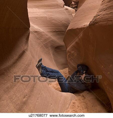 Stock Photo - Woman photographing in a slot canyon, Corkscrew Canyon, Lower Antelope Canyon, Antelope Canyon, Page, Arizona, USA. Fotosearch
