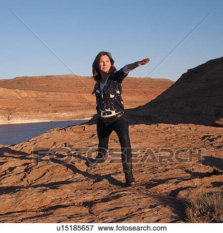 Woman practicing yoga at the lakeside, Lake Powell, Glen Canyon National Recreation Area, Arizona-Utah, USA View Large Photo Image Stock Photo - Woman practicing yoga at the lakeside, Lake Powell, Glen Canyon National Recreation Area, Arizona-Utah, USA. Fotosearch
